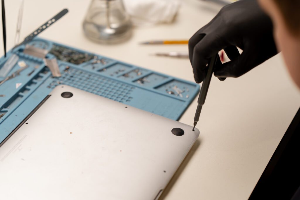 Apple computer repair in Kelowna at Repair Express, with a MacBook inspected for electronic repair and performance issues.