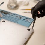 Apple computer repair in Kelowna at Repair Express, with a MacBook inspected for electronic repair and performance issues.