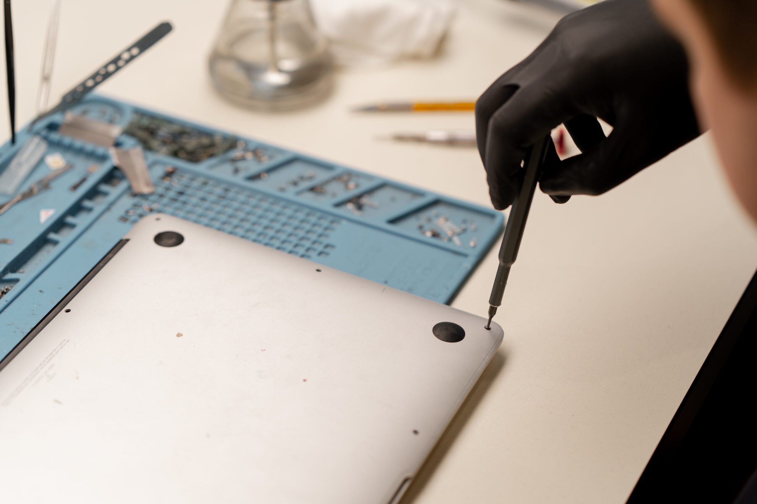 Apple computer repair in Kelowna at Repair Express, with a MacBook inspected for electronic repair and performance issues.