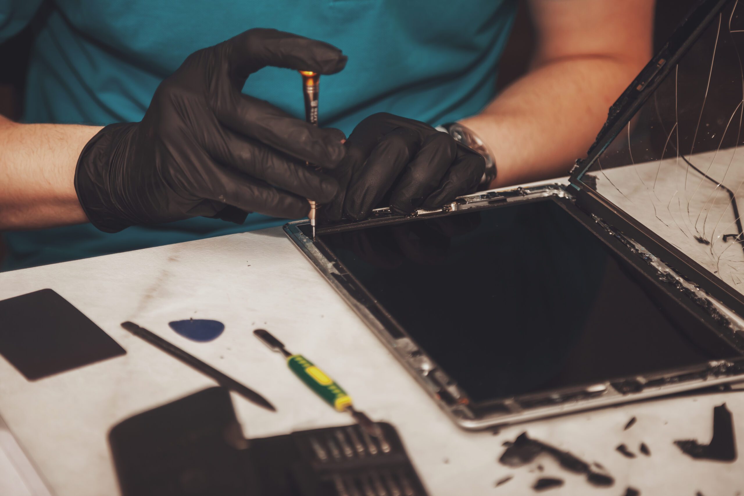 Technician performing iPad screen repair at Repair Express in Kelowna
