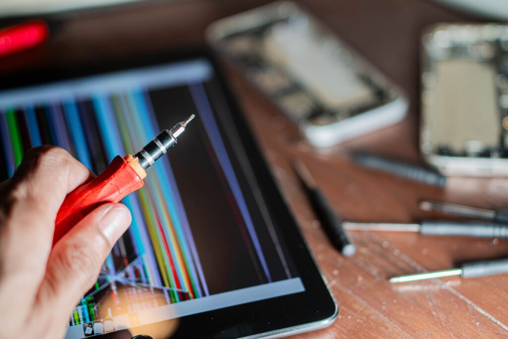 An iPad with a cracked screen before service begins.