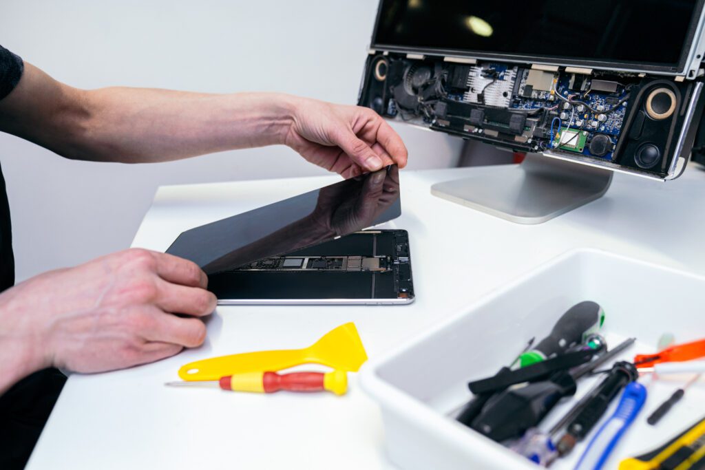 iPad secured on a repair mat with tools ready